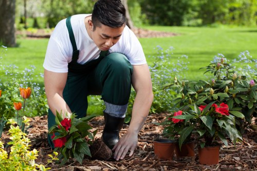 Operator inspecting machinery before use on a garden site